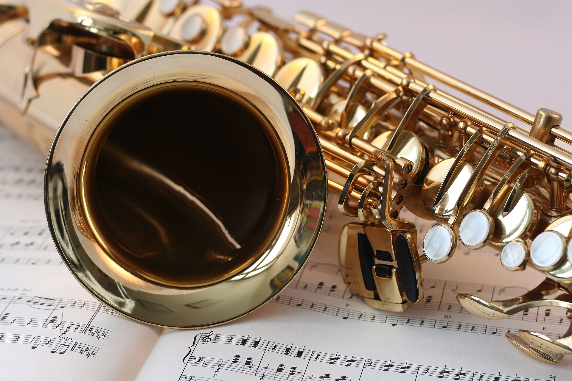 Saxophone resting on sheet music